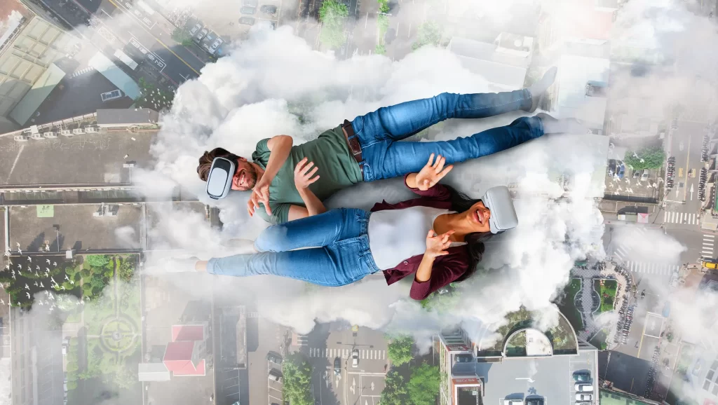 Two young adults wearing virtual reality headsets lying on a cloud-like surface with a cityscape in the background